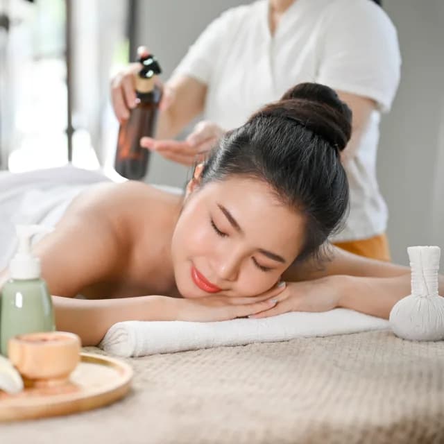 Relaxed woman receiving a body massage at a spa wellness salon